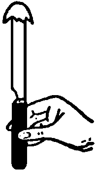 Butter knife held upright with half-eggshelll balanced on top.